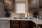 KITCHEN SINK AREA WITH A KEURIG & A REG. COFFEE MAKER